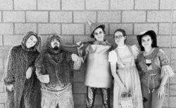 Picture of cast members dressed up as characters from The Wizard of Oz. Picture is black and white.